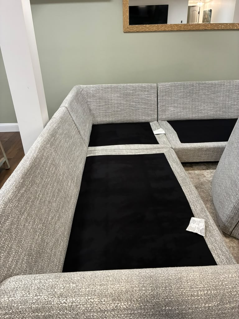 Sectional sofa lifted and vacuumed underneath